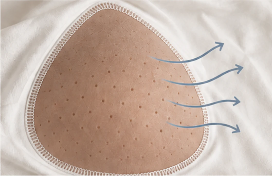 Construction illustration of a perforated bra cup with stitching around its edge.