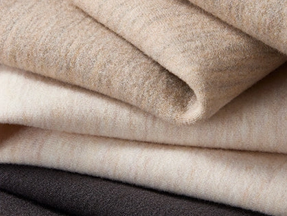 Close-up of folded scuba fabric in light and dark colors.